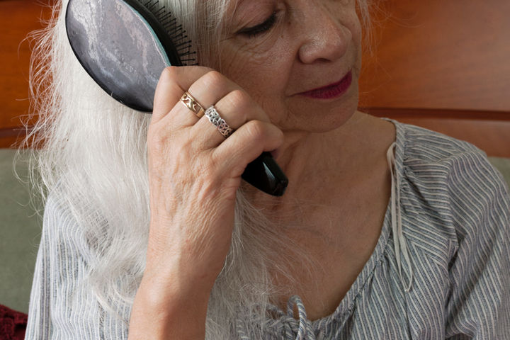 Caregiver brushing a senior's hair